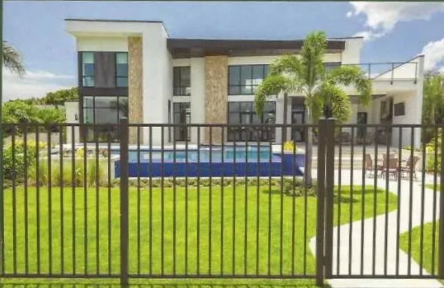 Black Ultra Aluminum fence enclosing a backyard swimming pool